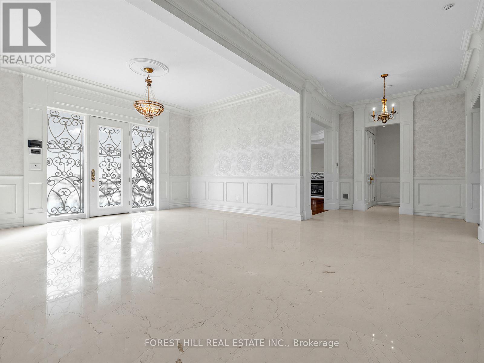 A spacious room with marble flooring and white walls.