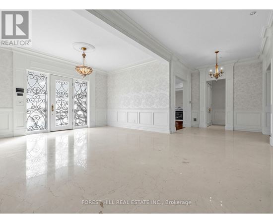 A spacious room with marble flooring and white walls.
