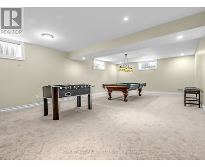 A room with a foosball table and a pool table.