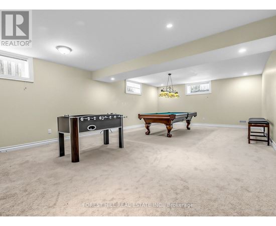 A room with a foosball table and a pool table.
