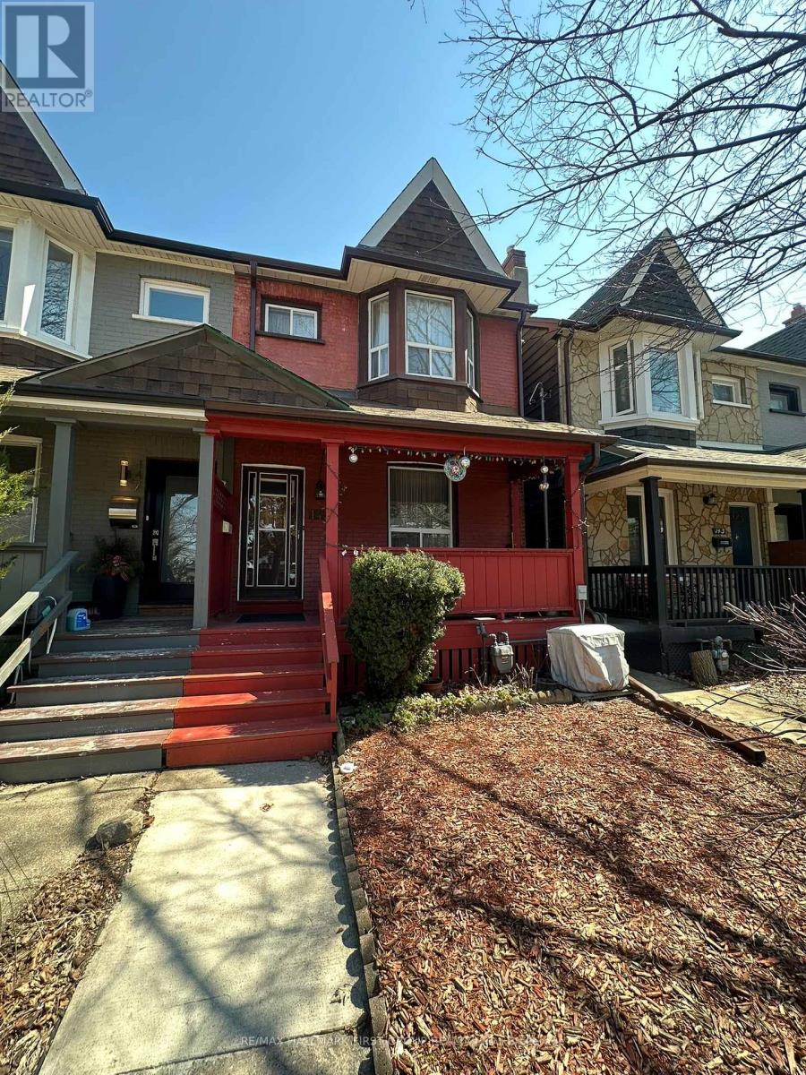 A red house with a white door and windows.