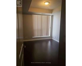 A room with a window covered with blinds.