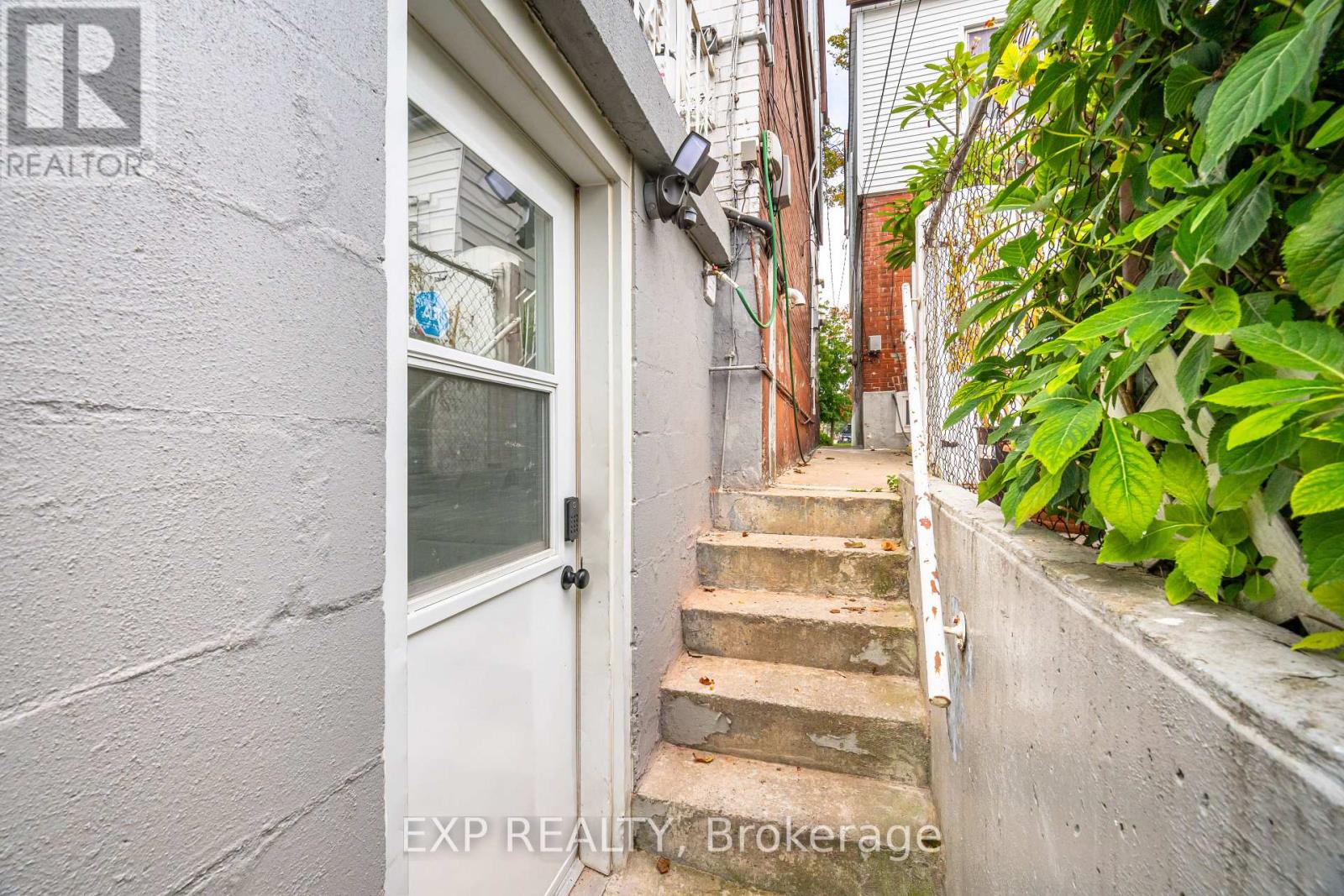 A white door is at the end of a staircase.