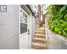 A white door is at the end of a staircase.
