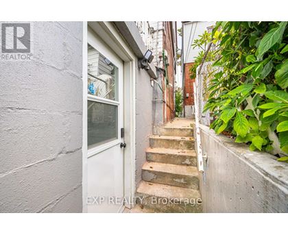 A white door is at the end of a staircase.