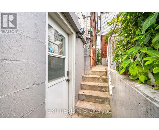 A white door is at the end of a staircase.