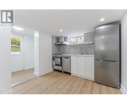 A kitchen with white cabinets and stainless steel appliances.