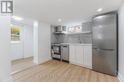 A kitchen with white cabinets and stainless steel appliances.