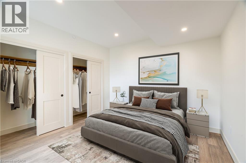 A bedroom with a large bed and a painting on the wall.