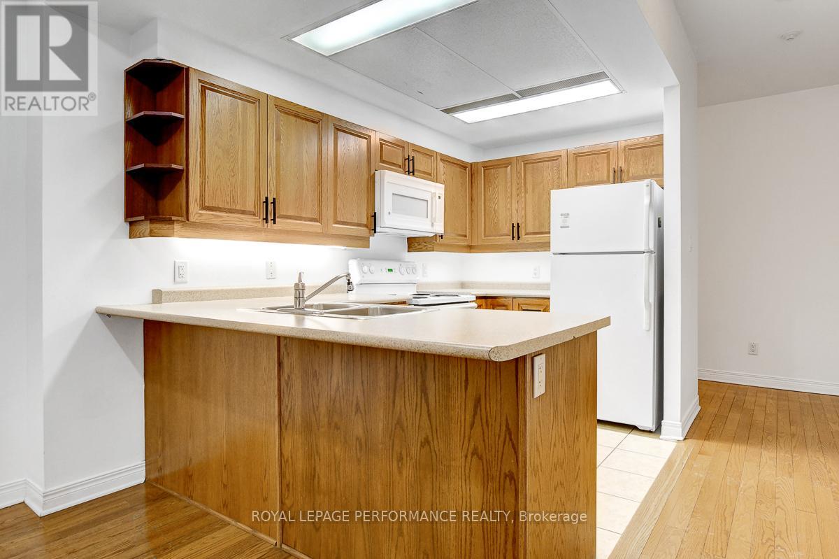 A kitchen with wooden cabinets and a white refrigerator.