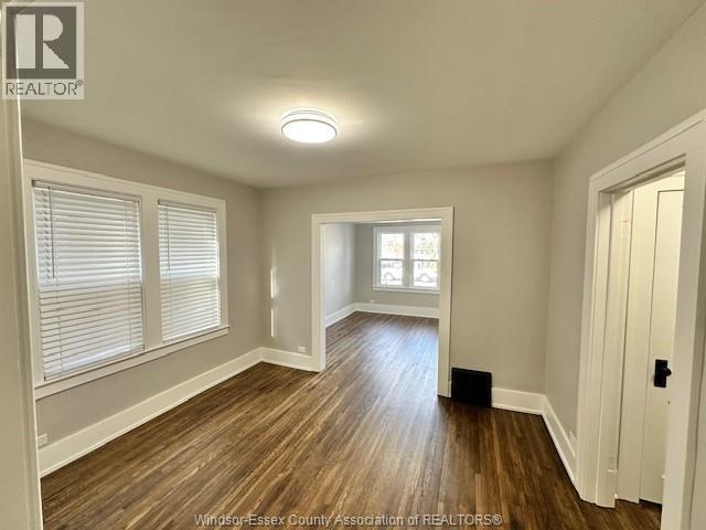 A room with wooden floors and white walls.