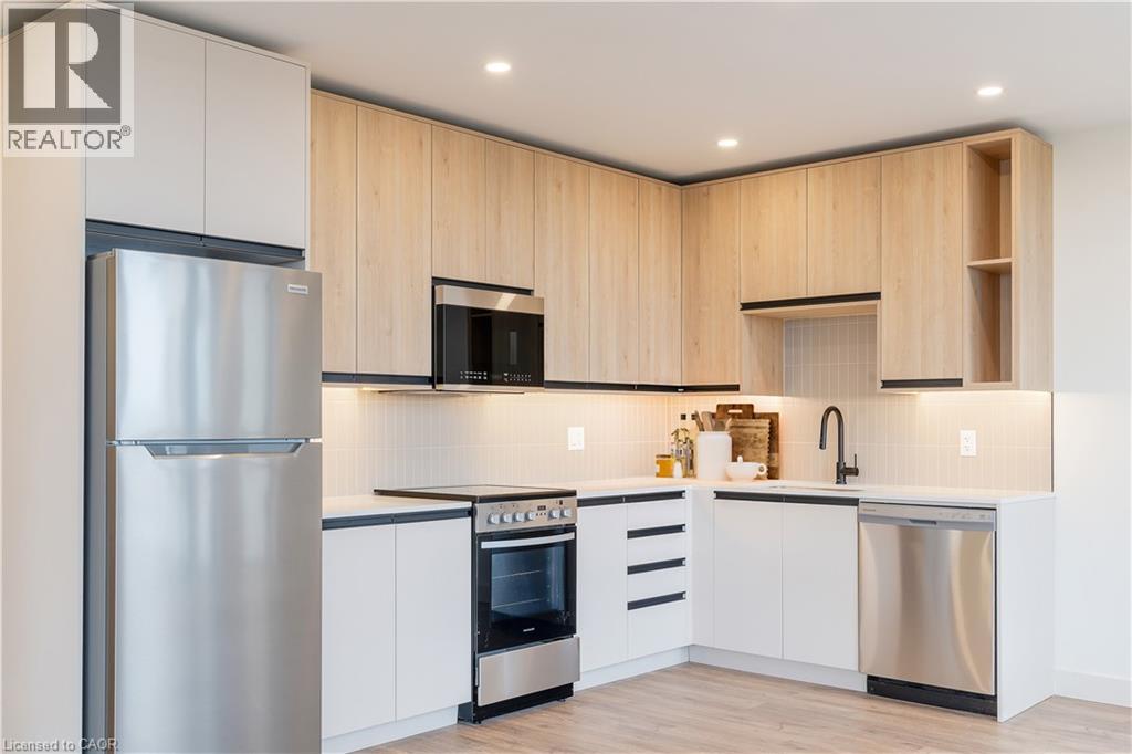 A modern kitchen with wooden cabinets and stainless steel appliances.