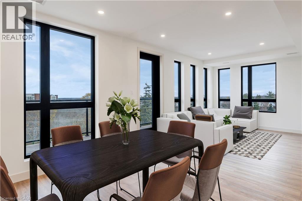A dining room with a table and chairs.