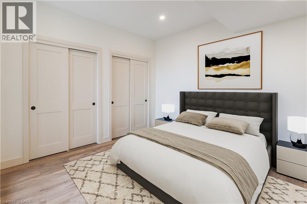 A bedroom with a large bed, two nightstands, and a painting on the wall.