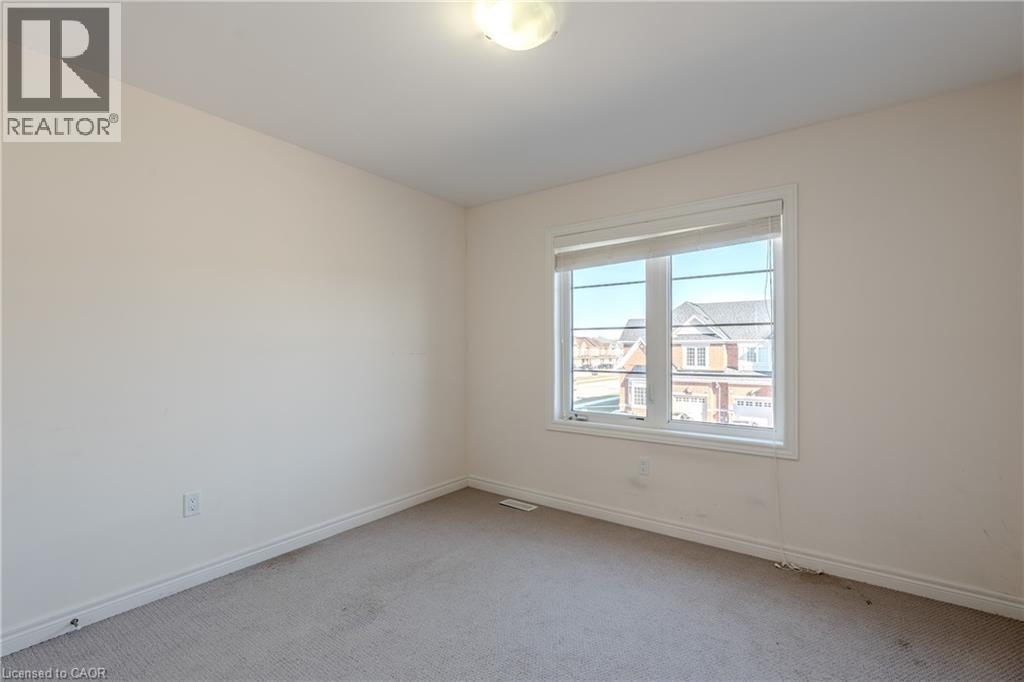 A room with a window showing a view of buildings outside.