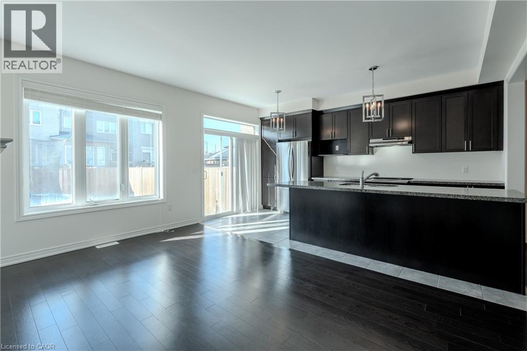 A modern kitchen with black cabinets and a large island.