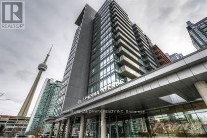 A tall building with a glass facade and a sign that reads "REALTOR".