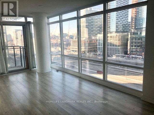 A room with a view of the city through large windows.
