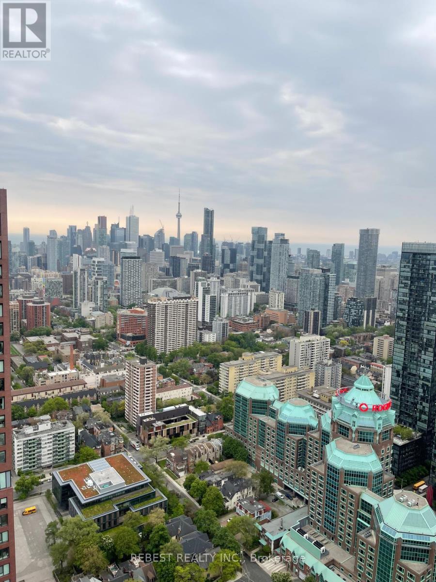 A cityscape with a mix of modern and older buildings, with a cloudy sky above.