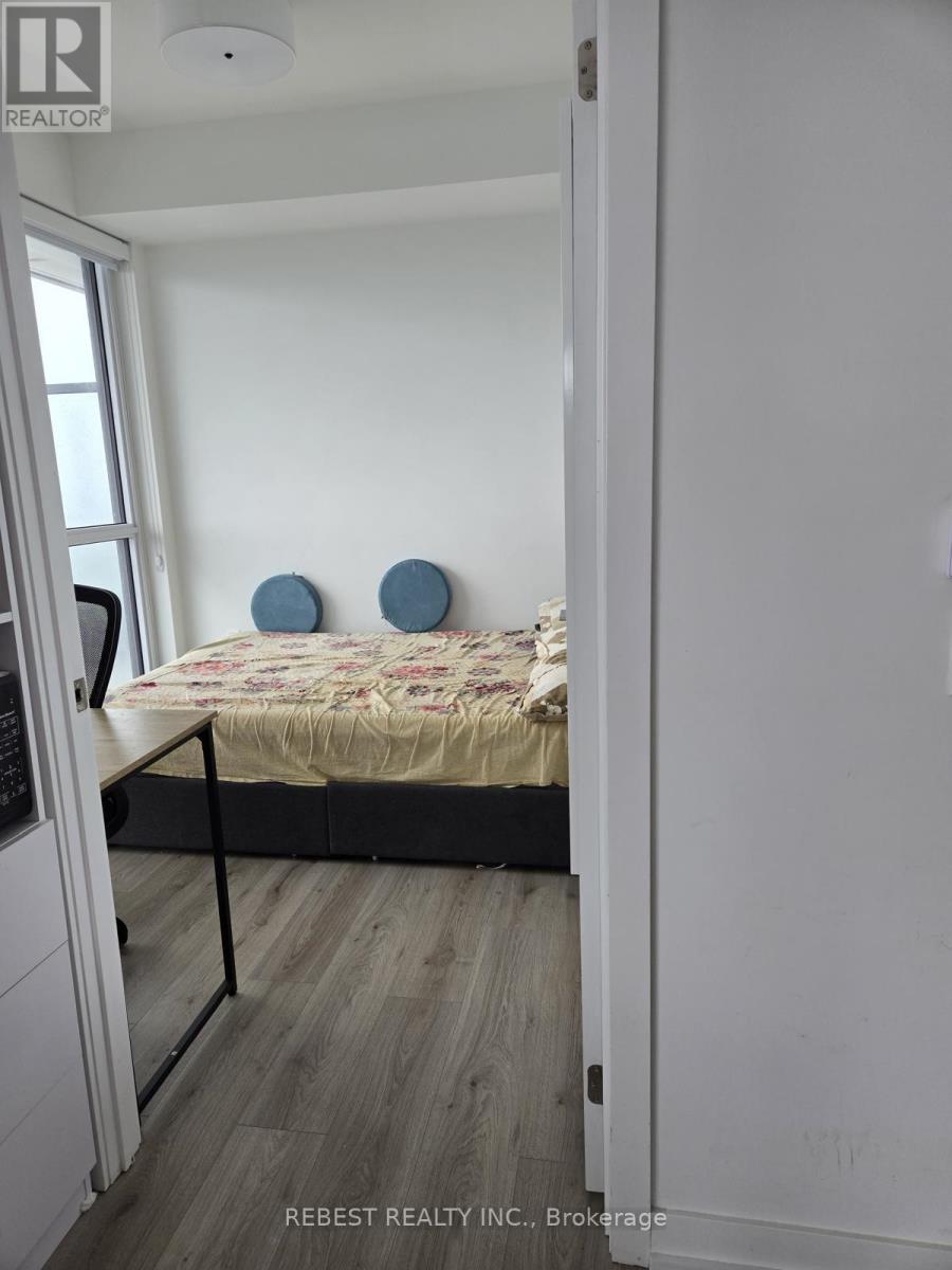 A bedroom with a bed and two blue circular objects on the wall.