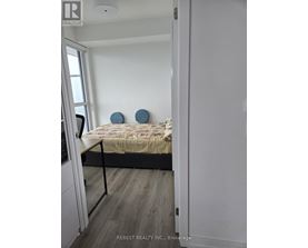 A bedroom with a bed and two blue circular objects on the wall.