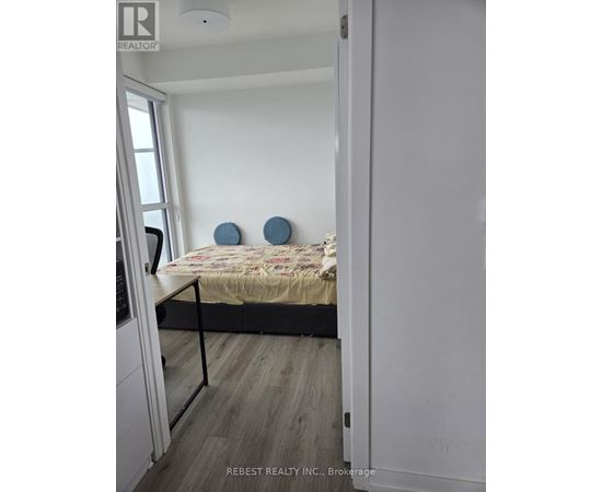 A bedroom with a bed and two blue circular objects on the wall.