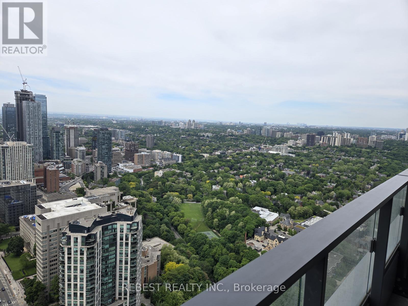 A cityscape with a mix of high-rise buildings and green spaces.