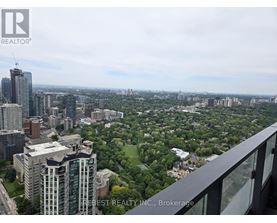 A cityscape with a mix of high-rise buildings and green spaces.