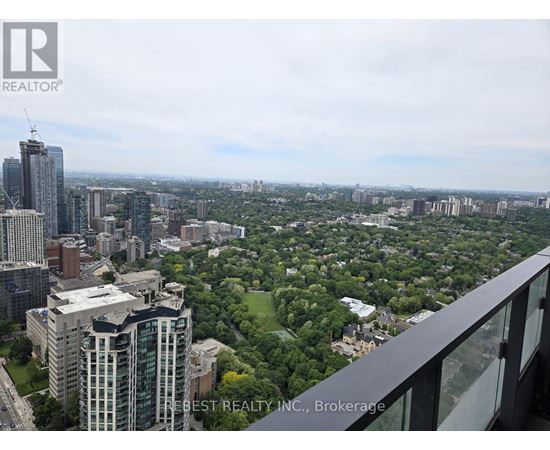 A cityscape with a mix of high-rise buildings and green spaces.