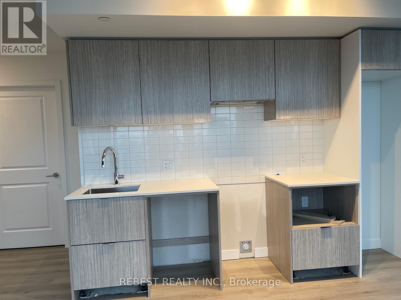 A kitchen with a sink and a cabinet.