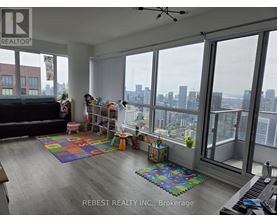 A living room with a view of the city skyline.