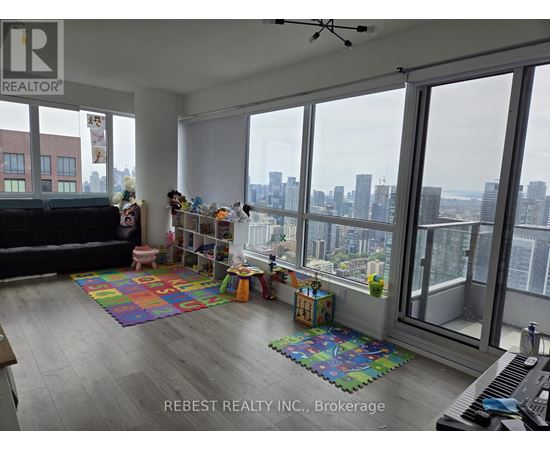 A living room with a view of the city skyline.