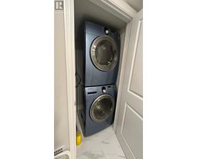 A washing machine is in a small space.