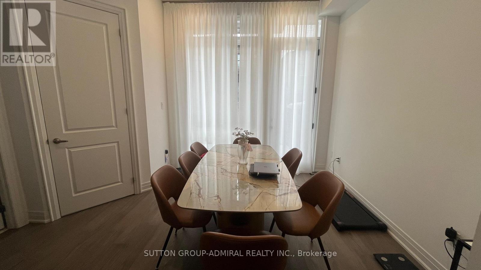 A dining room with a table set for six.