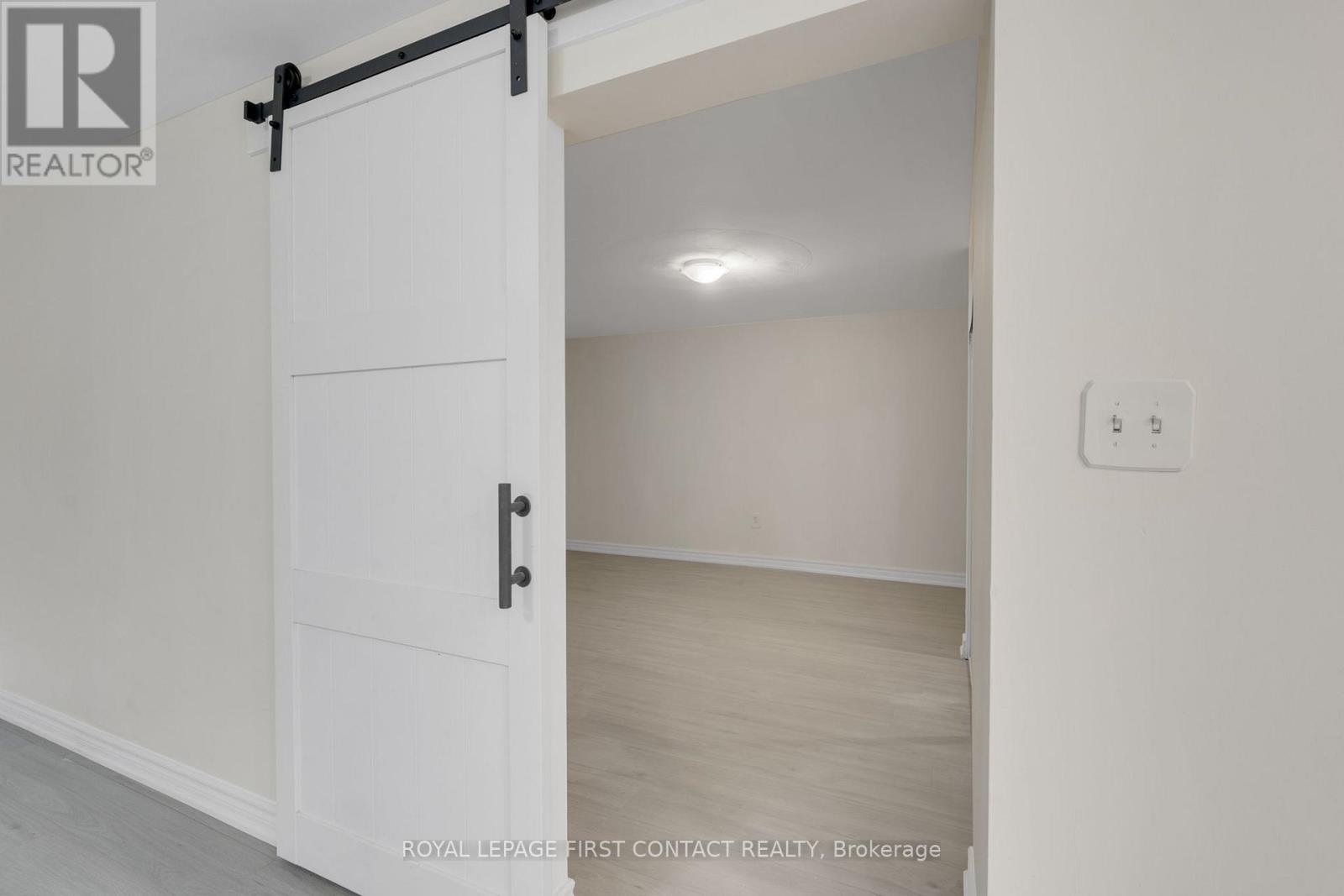 A white door with a black handle and a black bar above it.