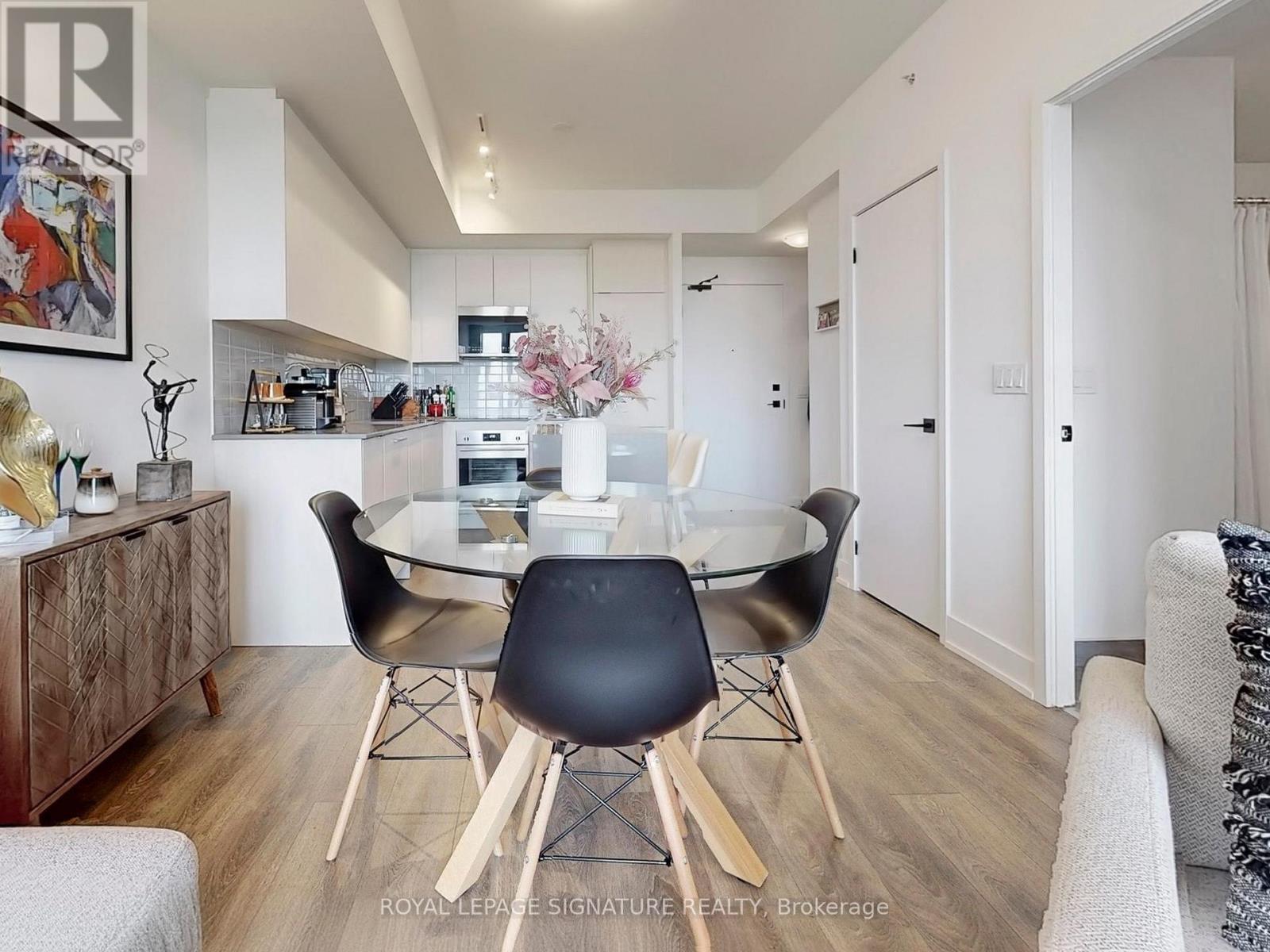 A dining room with a glass table and chairs.