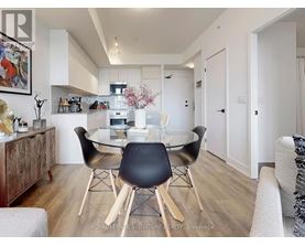 A dining room with a glass table and chairs.