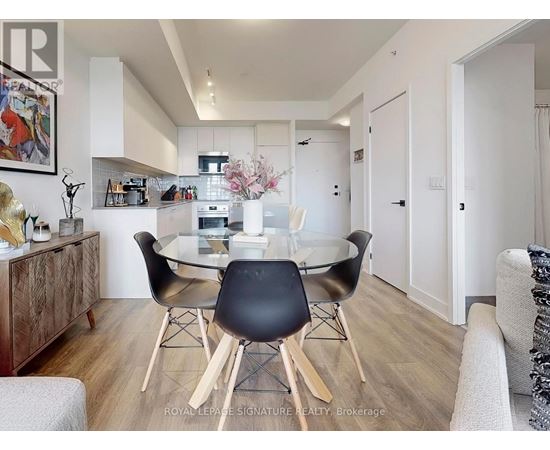A dining room with a glass table and chairs.