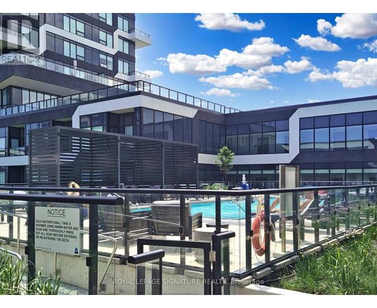 A pool area with a notice sign on the fence.