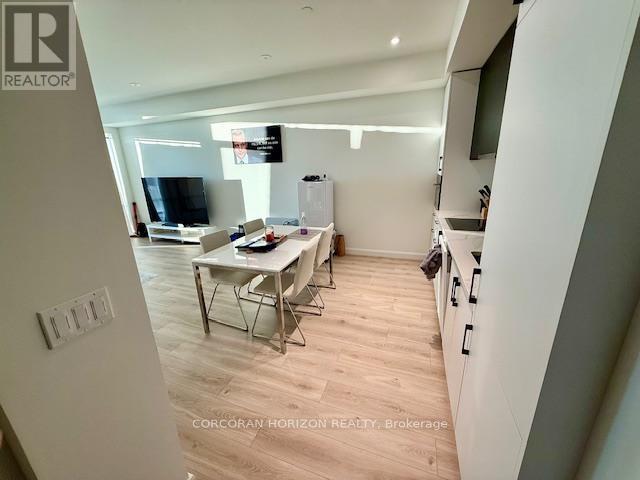 A modern kitchen with a dining table and chairs.