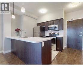 A kitchen with dark wood cabinets and stainless steel appliances.