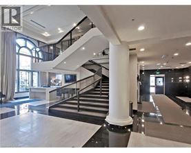A spacious interior of a building with a staircase and a reception area.