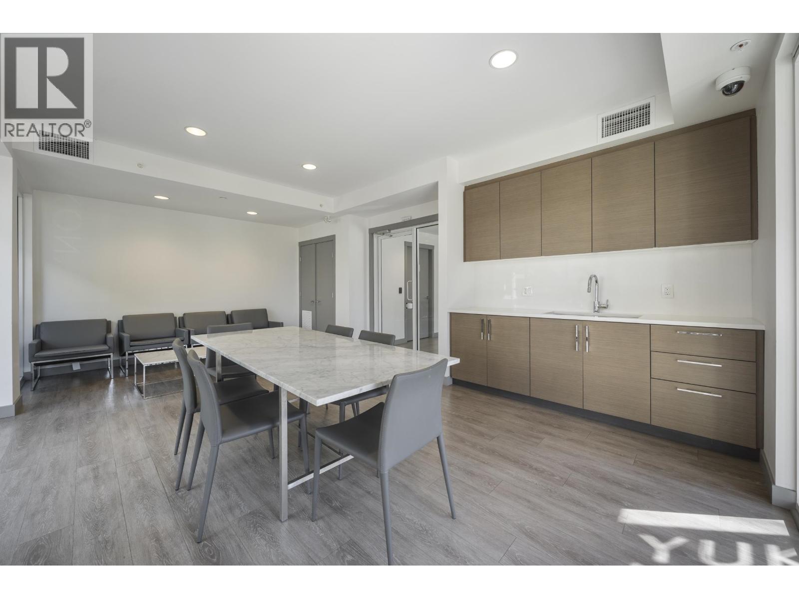 A modern dining room with a table and chairs.