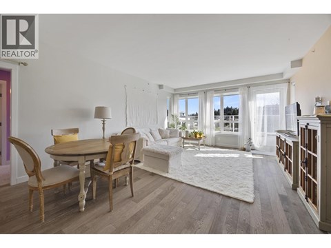 A living room with a dining table and chairs.
