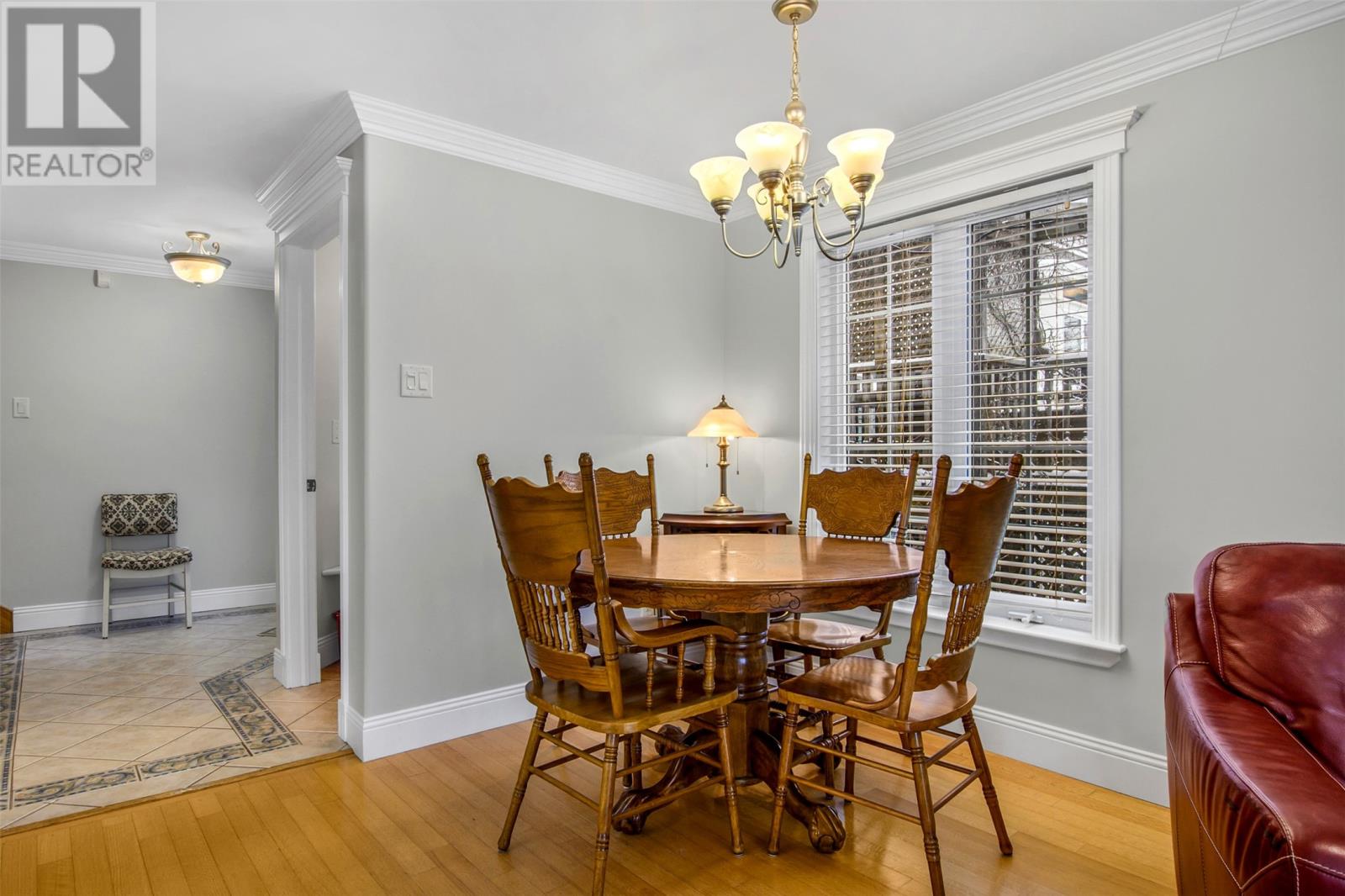 A dining room with a wooden table and chairs.