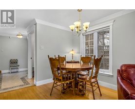 A dining room with a wooden table and chairs.
