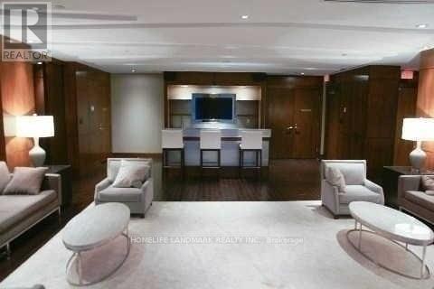 A living room with a white couch and a television.