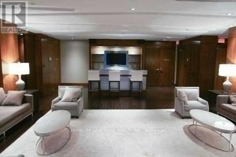 A living room with a white couch and a television.