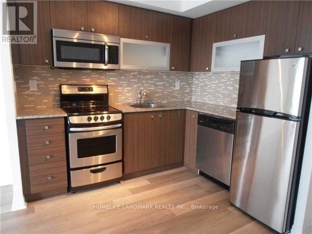 A kitchen with wooden cabinets and stainless steel appliances.