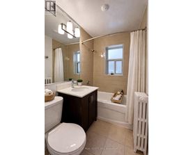 A bathroom with a toilet, sink, and bathtub.